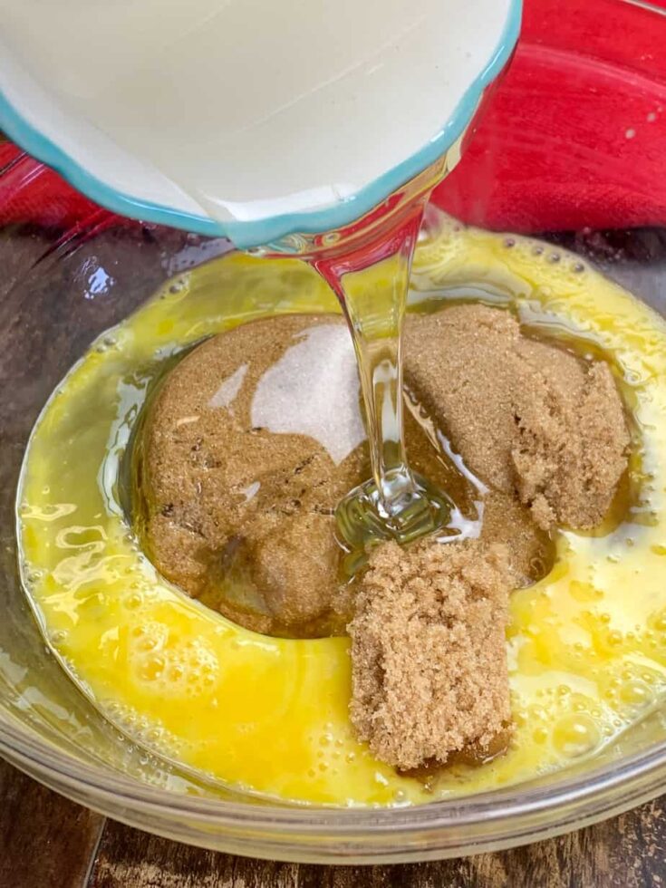 Corn syrup, brown sugar, and eggs in a glass bowl