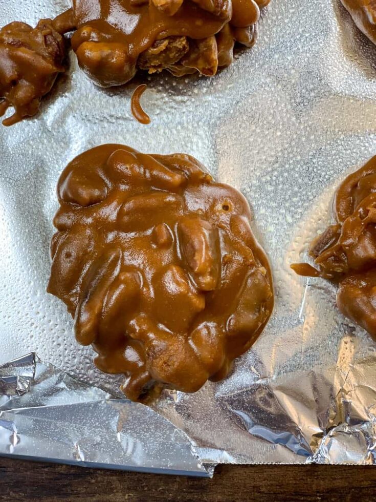 Praline pecans sitting on tinfoil