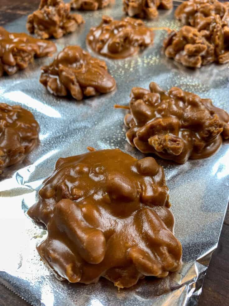 Praline pecans sitting on tinfoil