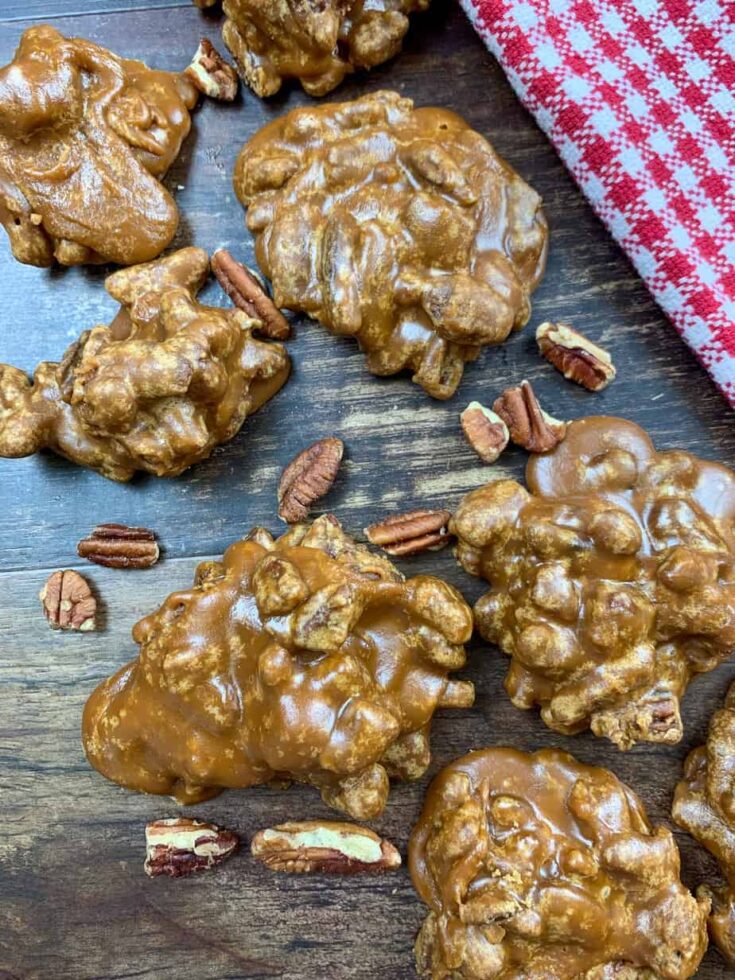 Praline pecans on a counter with pecans.