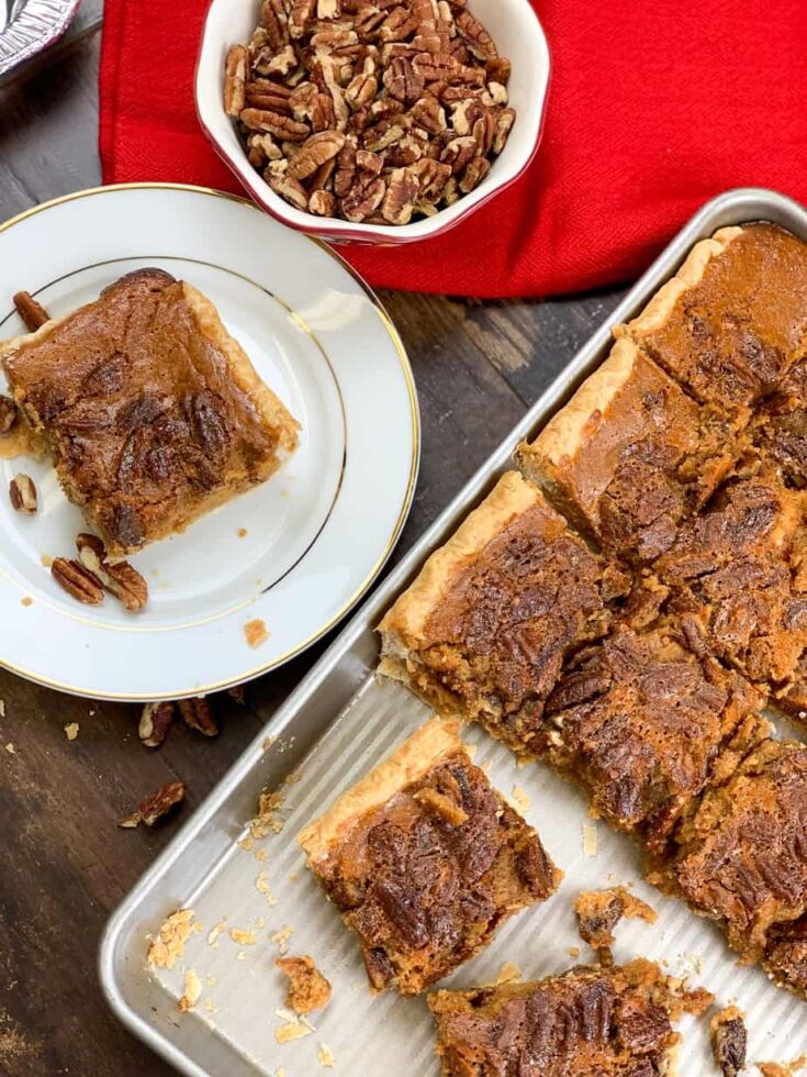 Pumpkin pecan pie bars on a plate and in a jelly roll pan