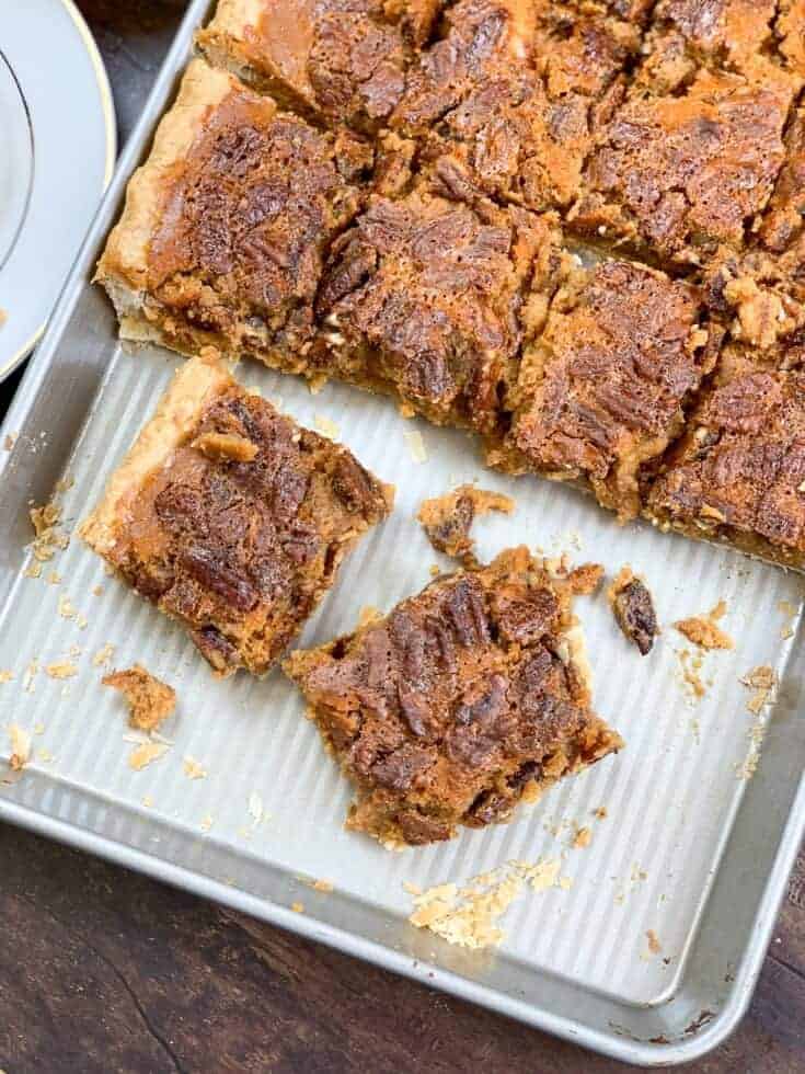 Pumpkin pecan pie bars cut up on a jelly roll pan