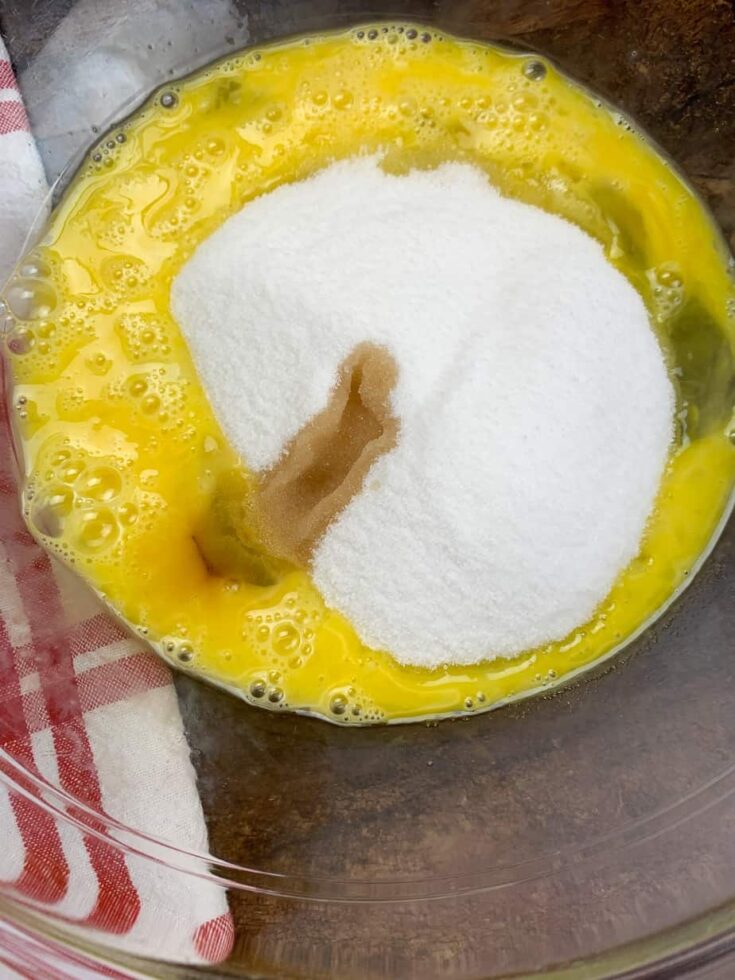 Sugar, vanilla, and eggs in a bowl