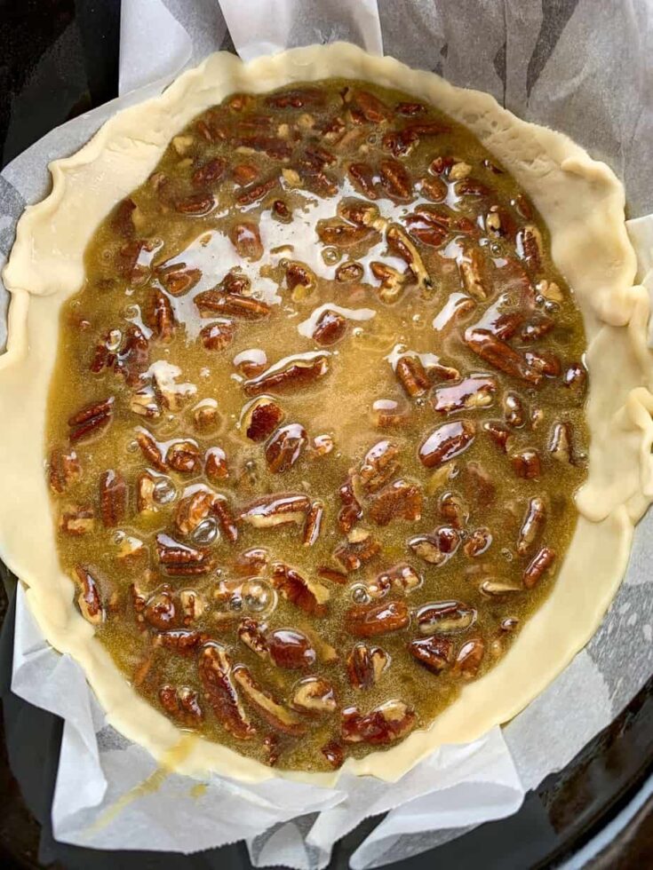 Pecan pie filling in a pie shell in a Crock Pot