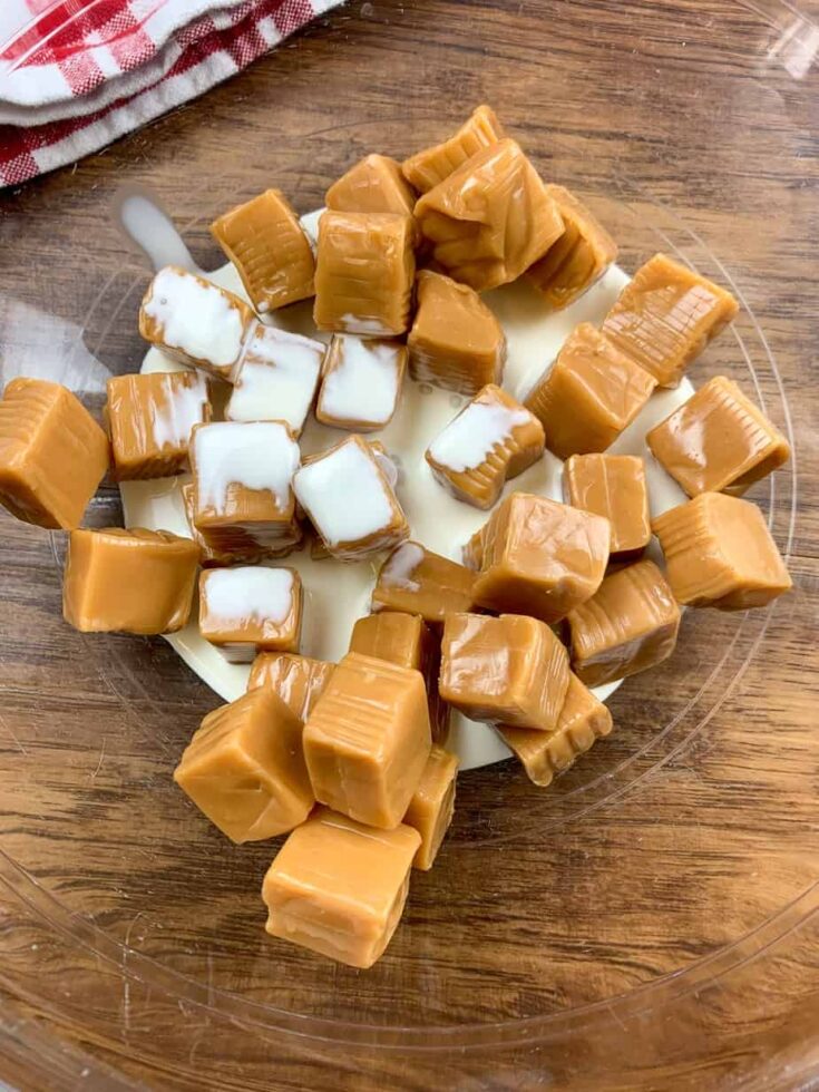 Caramels and heavy cream in a glass bowl