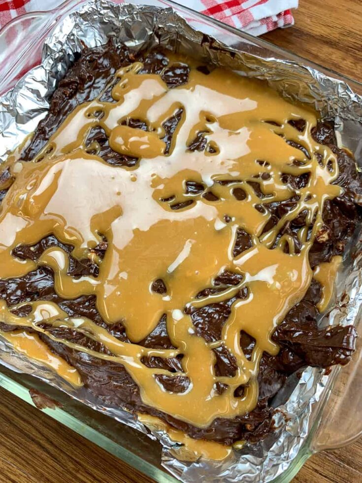 Caramel drizzled over the top of melted chocolate fudge. 