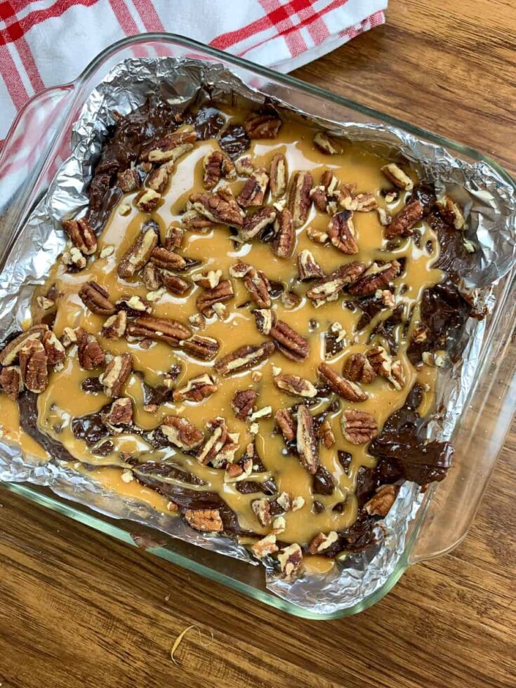 Chocolate fudge with caramel and pecans in a dish 