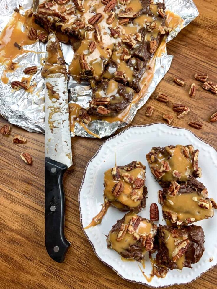 Chocolate turtle fudge on a plate and on some tinfoil.