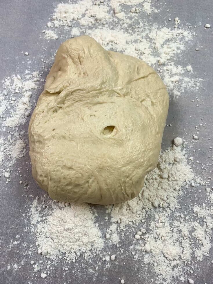 Pizza dough on a counter with flour