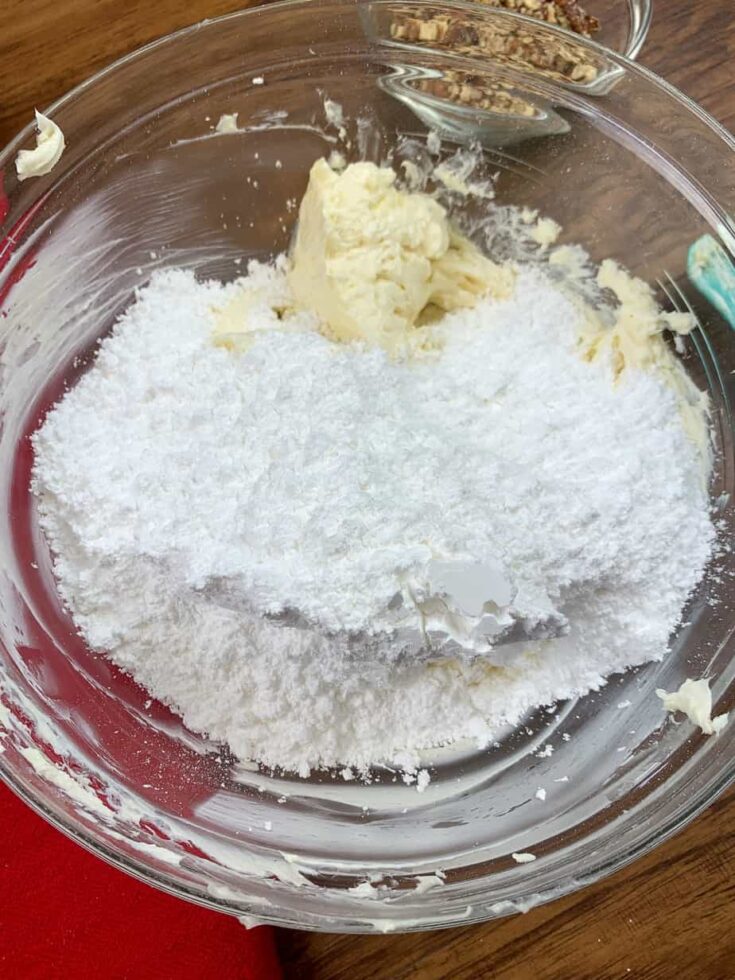 Powdered sugar, cream cheese, and butter in a bowl