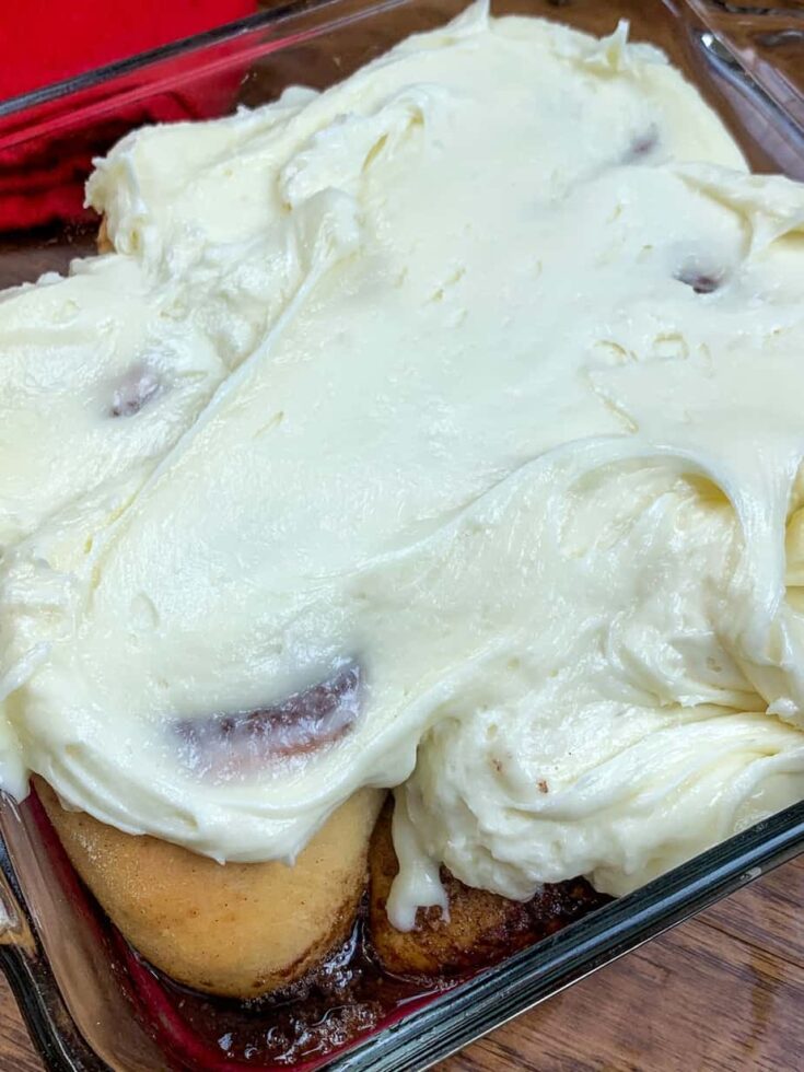 Cream cheese frosting on top of cinnamon rolls. 