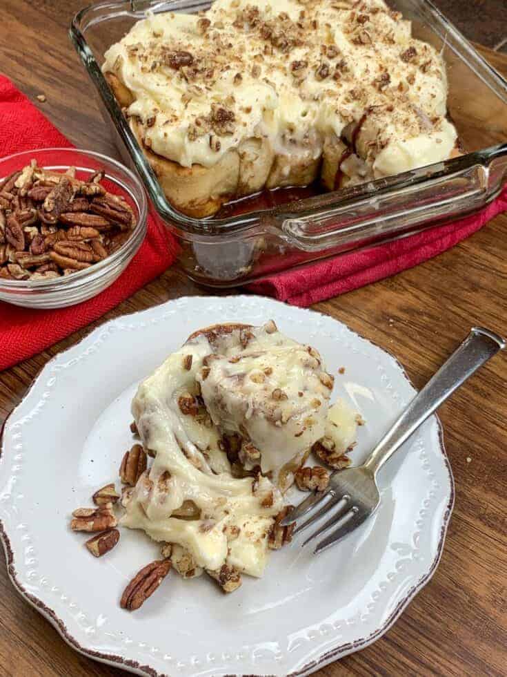 Cinnamon rolls in a dish and on a plate with pecans