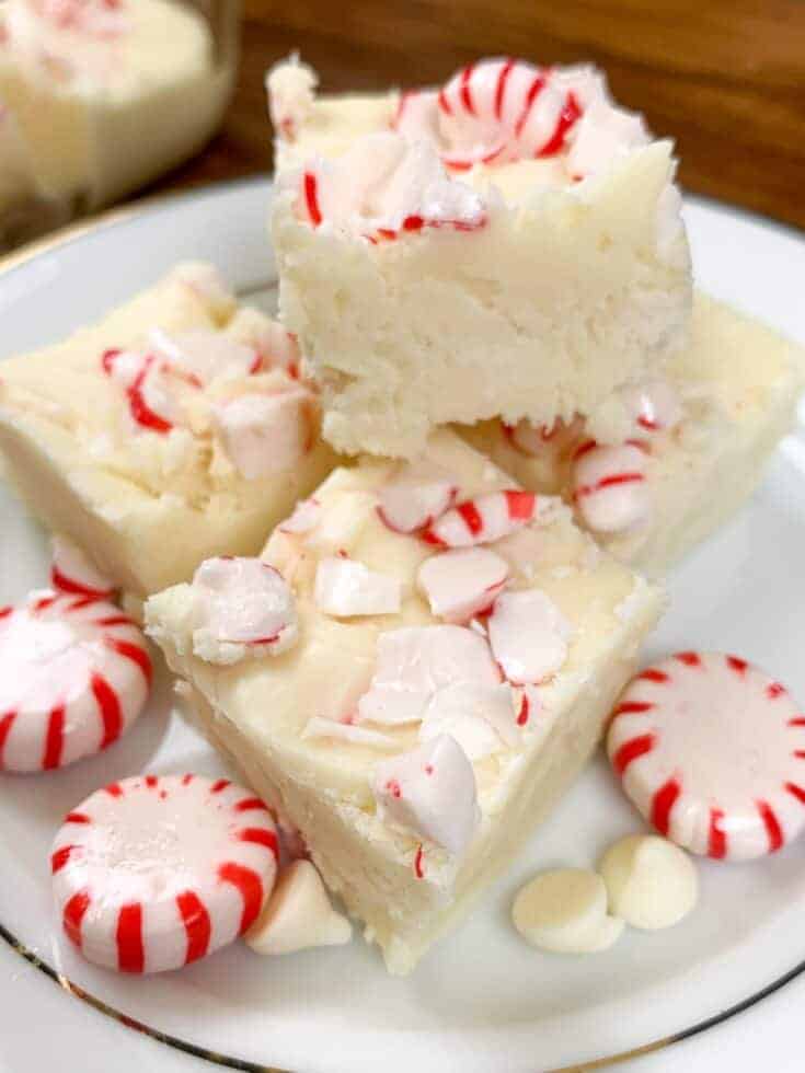 Peppermint fudge on a plate with peppermint candies