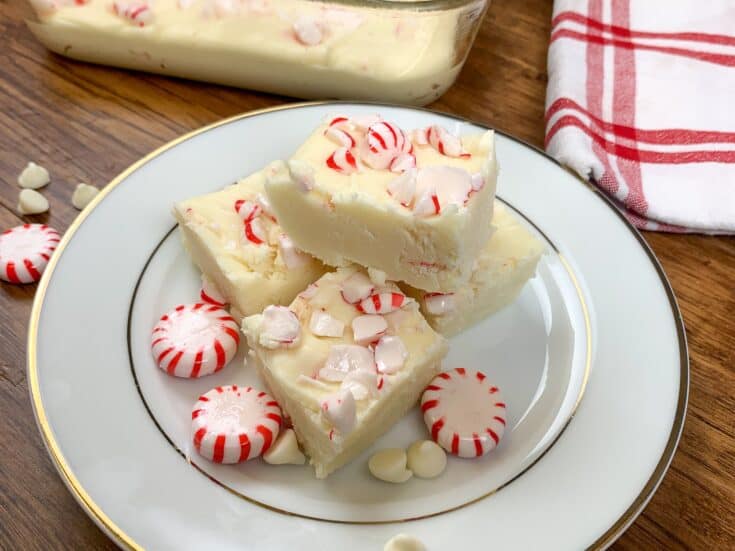 Peppermint fudge on a plate with peppermint candies