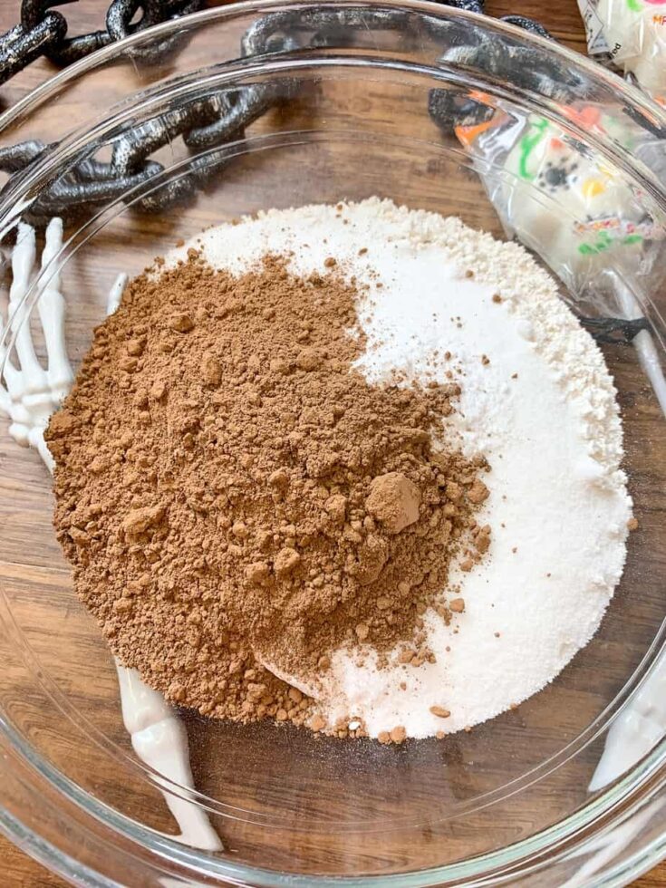 Sugar, flour, and unsweetened cocoa in a glass bowl