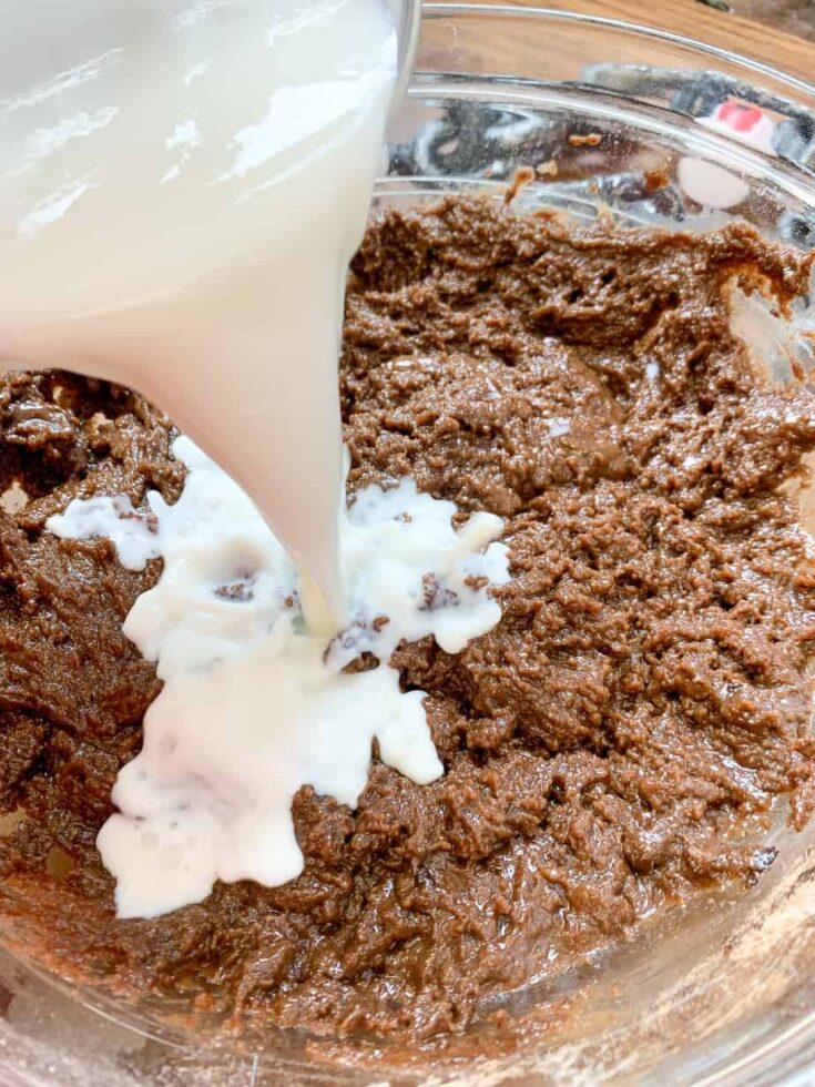 Milk being poured into Halloween cake batter