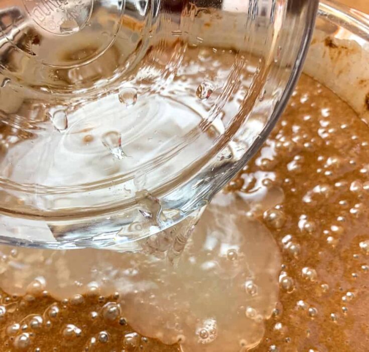 Water being poured into Halloween cake batter