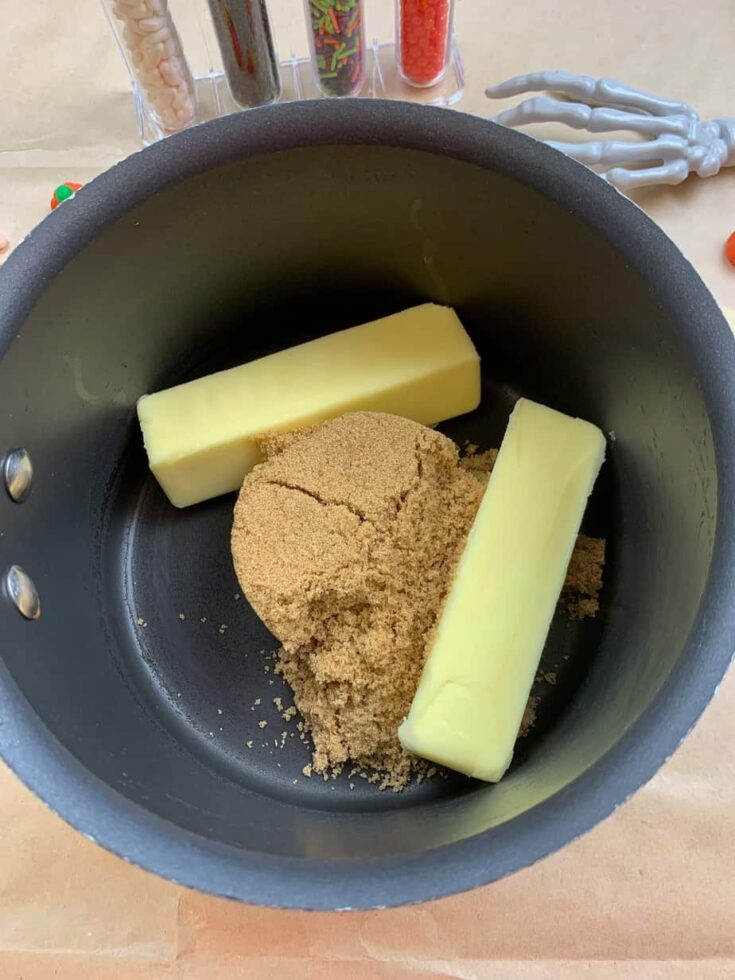 Butter and brown sugar in a saucepan making cracker candy