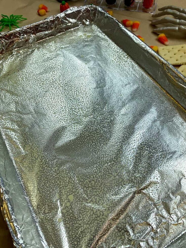 Tin foil on a cookie sheet with non-stick spray for cracker candy