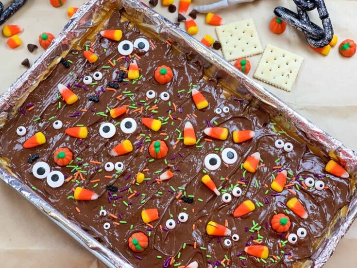 Chocolate crack on a cookie sheet with Halloween candy decorations