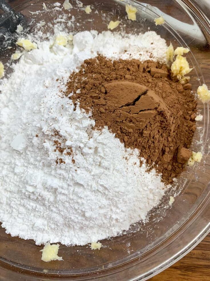 Butter, powdered sugar, and cocoa in a glass bowl