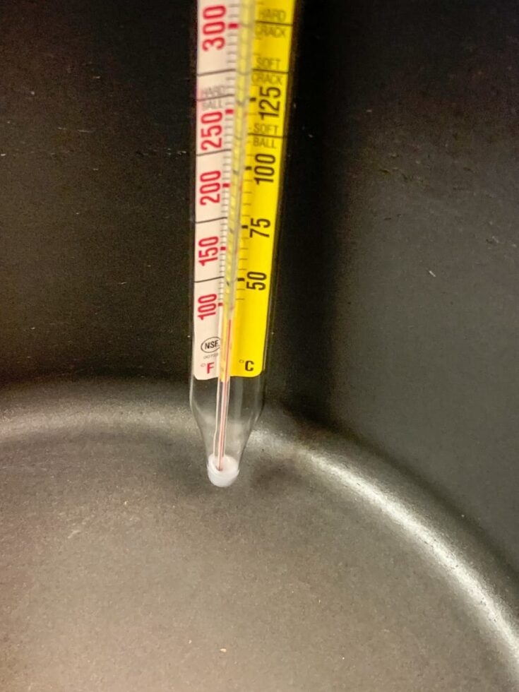 A thermometer on the side of a saucepan.