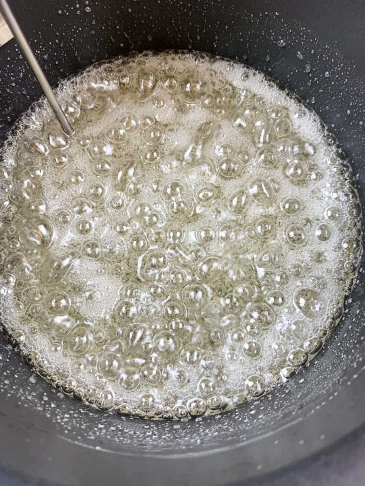 Boiling sugar, corn syrup, and water in a saucepan