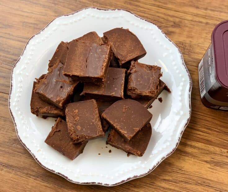 Chocolate fudge cut up into pieces and sitting on a plate