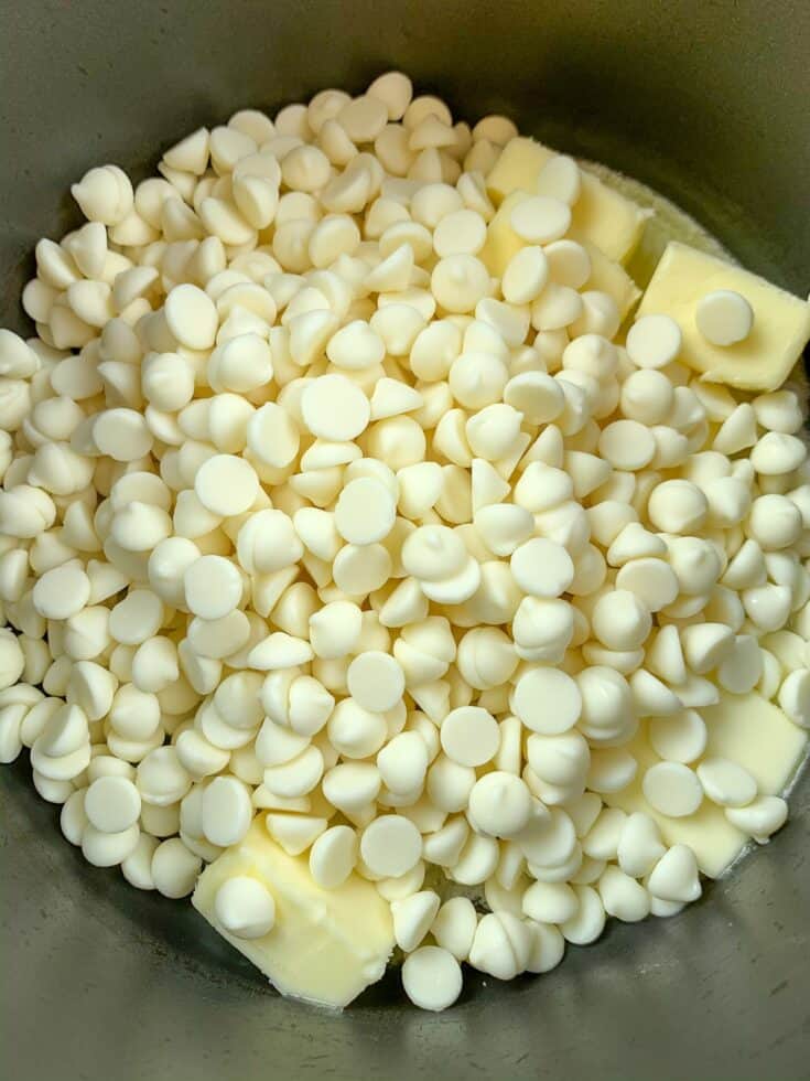 White chocolate chips in a saucepan with melting butter to make peanut butter fudge