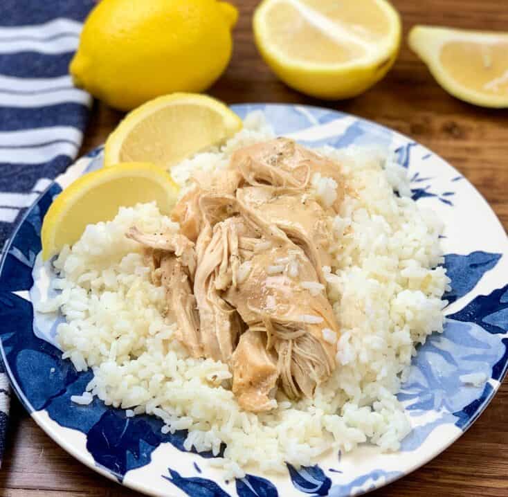 Lemon chicken on a plate with rice and lemons