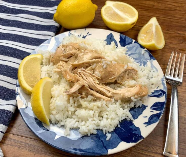 Lemon chicken and rice on a plate with lemons