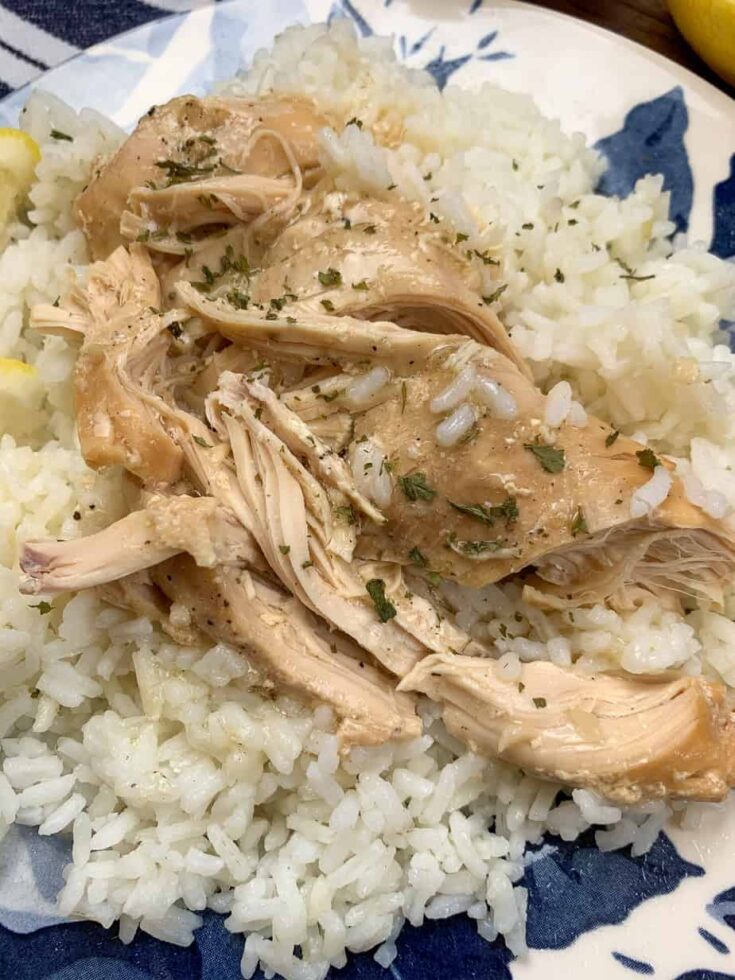 Shredded chicken with lemon sauce on top of a bed of rice