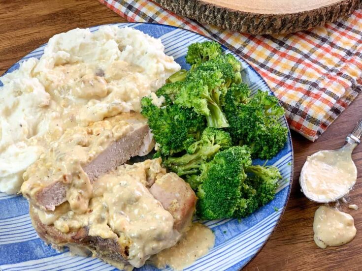 Pork chops on a plate with broccoli and mashed potatoes