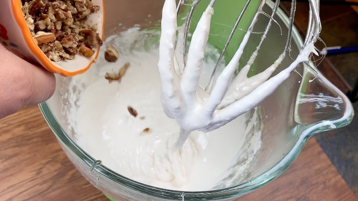 Pouring pecans into divinity fudge mixture