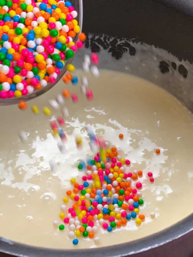 Pouring funfetti into the white chocolate