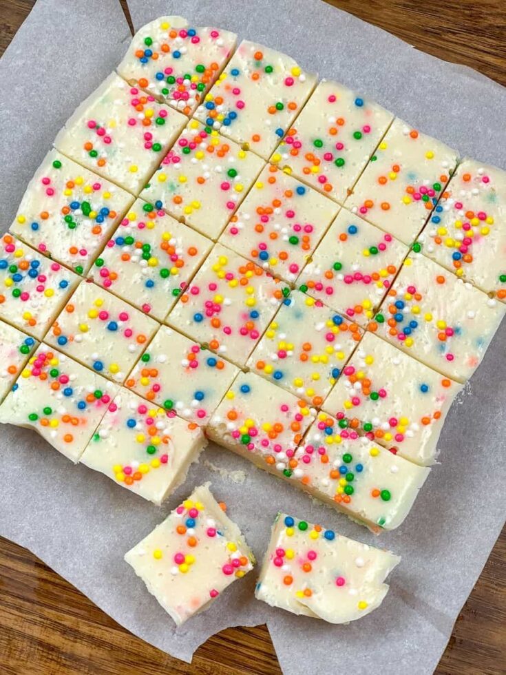 Funfetti fudge cut up on parchment paper