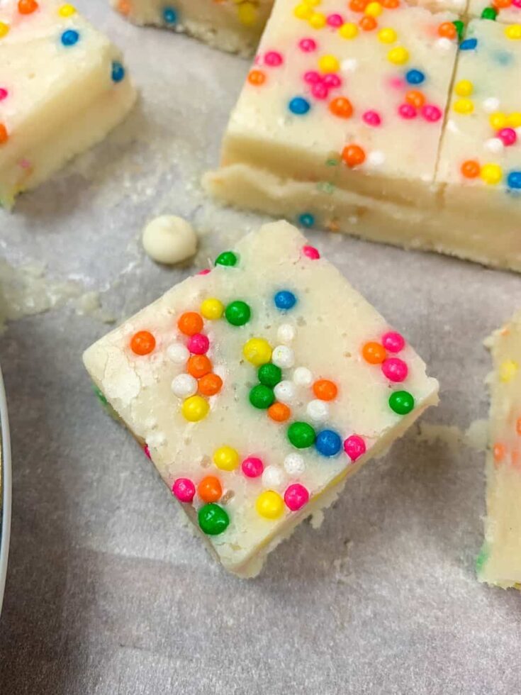 Funfetti fudge cut up on parchment paper