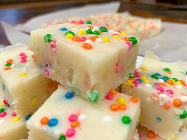 Funfetti fudge stacked on top of a white plate