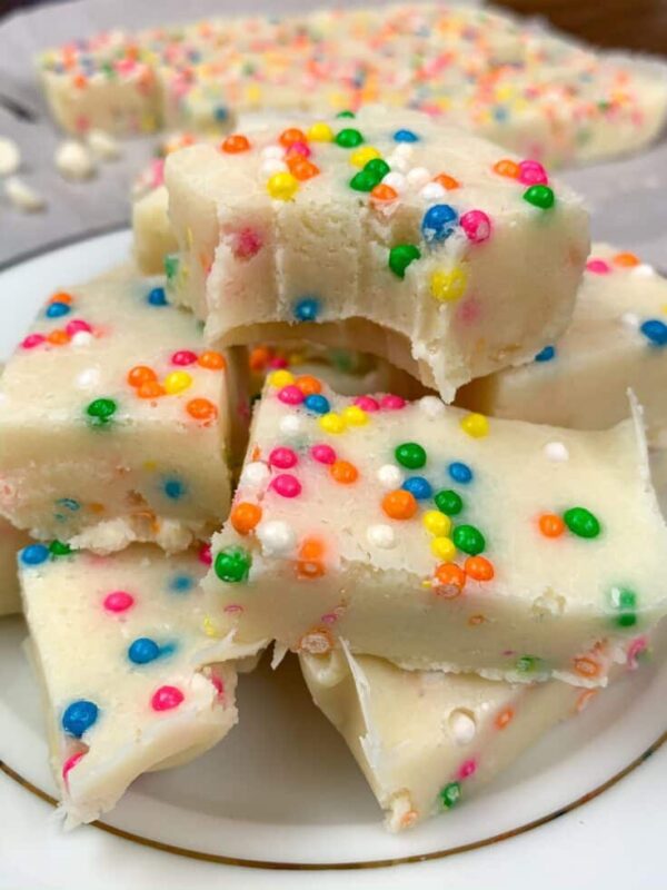 Funfetti fudge cut up and sitting on top of a plate