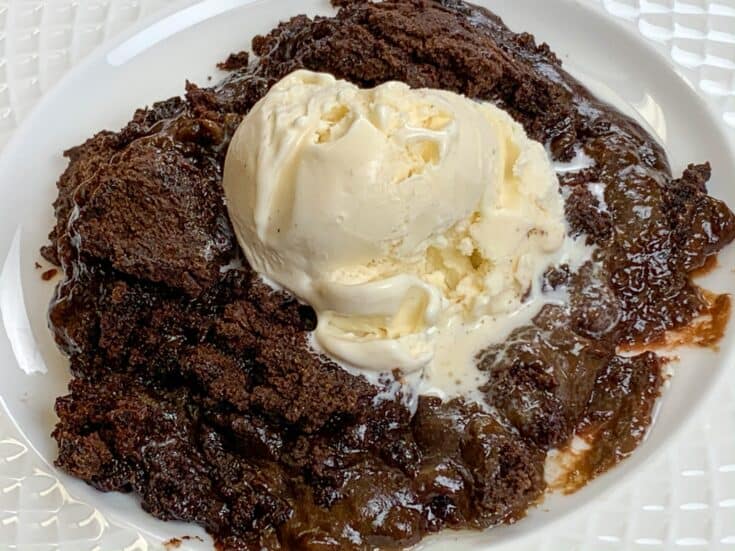 Slow cooker chocolate cake with a scoop of ice cream on a plate