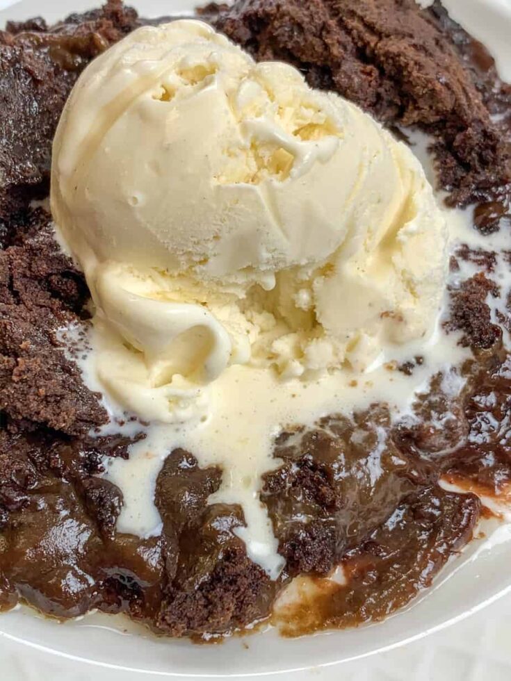 slow cooker cake with a scoop of ice cream on top