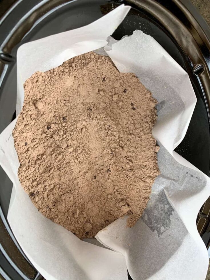 Boxed cake mix in a slow cooker with parchment paper