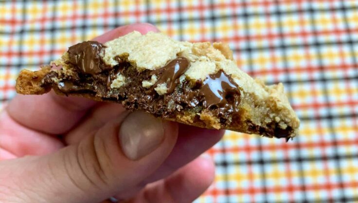 Chocolate chip cookie broken in half. 