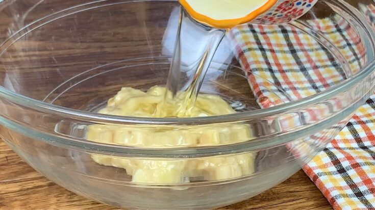 Vegetable oil being poured into a glass bowl