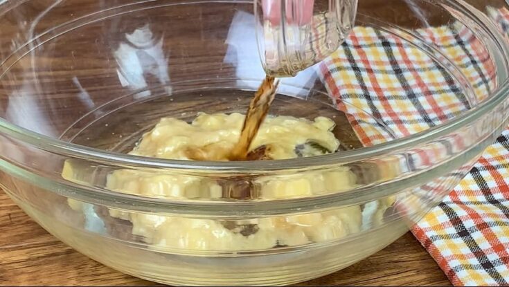 Pouring vanilla extract into a bowl.