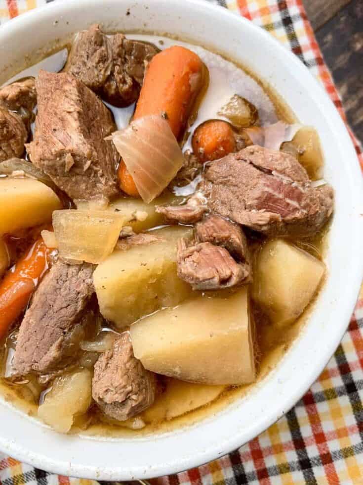 Slow cooker beef stew in a white bowl
