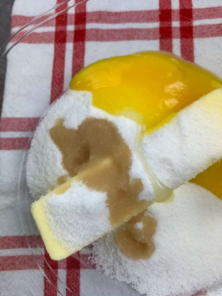 Butter, sugar, egg yolk, and vanilla in a large glass bowl