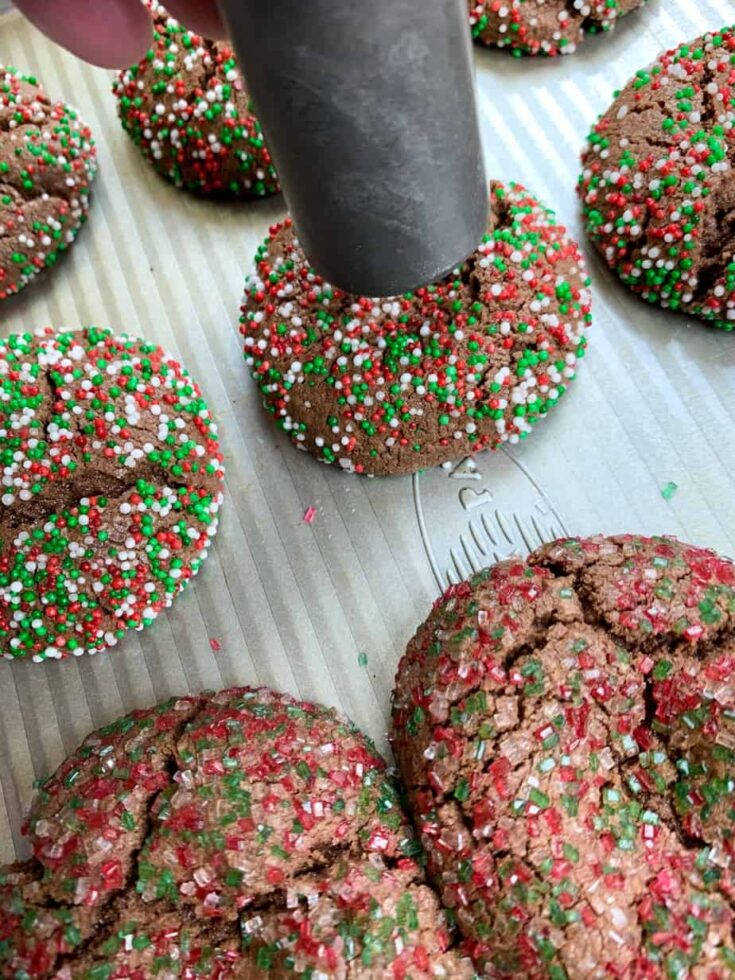 Pressing thumbprint cookies down with the end of an ice cream scoop