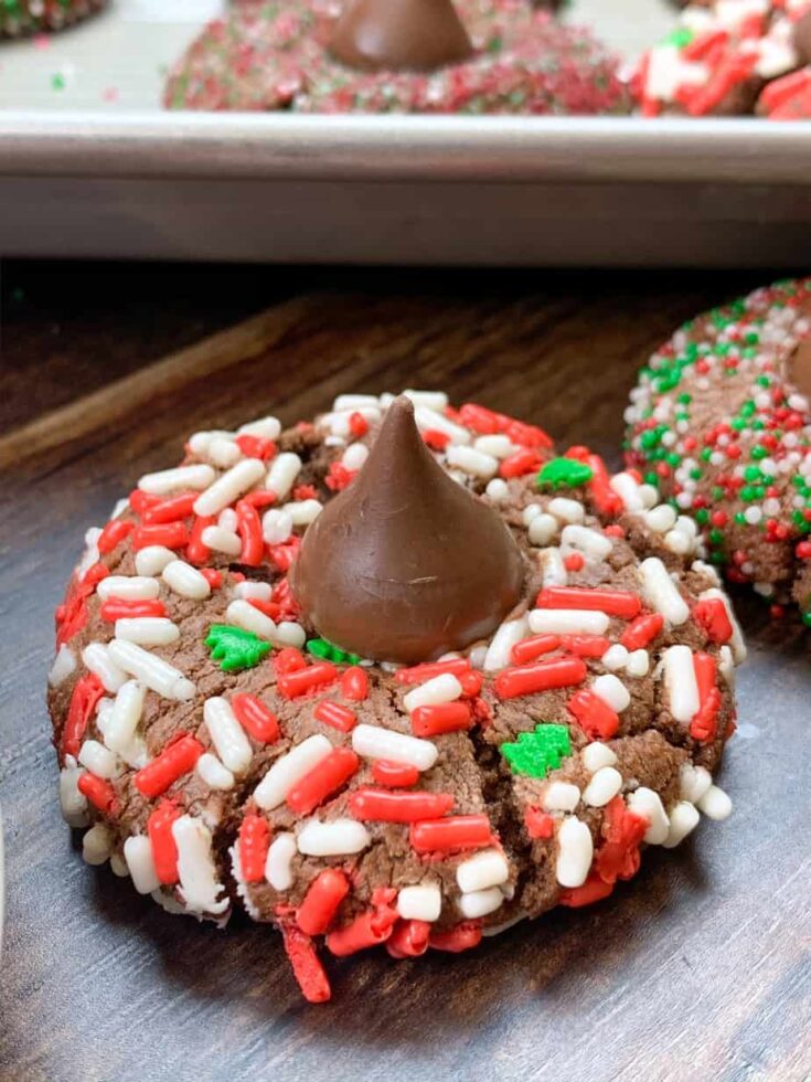 Thumbprint kiss cookies with a Hershey Kiss in the center on the counter