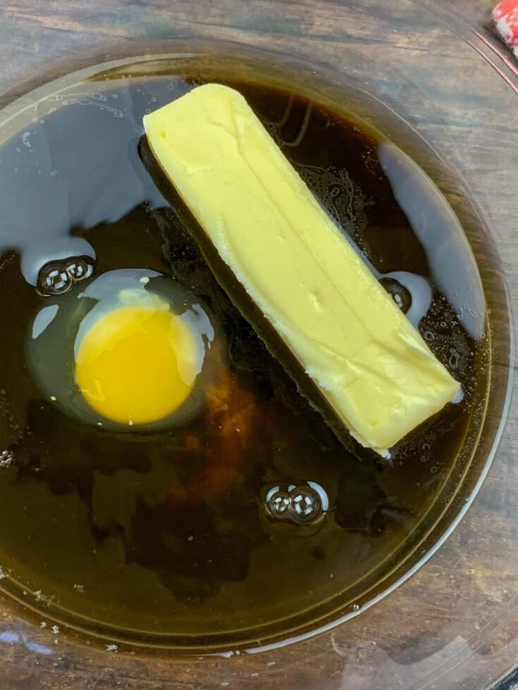 Sugar, molasses, butter, and egg in a glass bowl